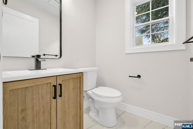 15 Monroe St, Garfield, NJ 07026 - bathroom featuring toilet, vanity, baseboards, and marble finish floors