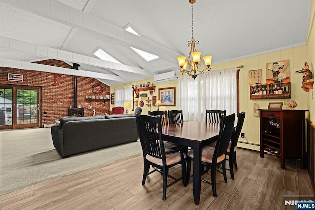 51 Sunrise Ter, Cedar Grove, NJ 07009 - dining space with a wood stove, a chandelier, wood finished floors, a wall mounted AC, and brick wall