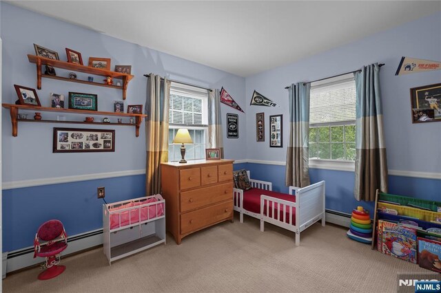 51 Sunrise Ter, Cedar Grove, NJ 07009 - bedroom with multiple windows, light colored carpet, and a baseboard heating unit