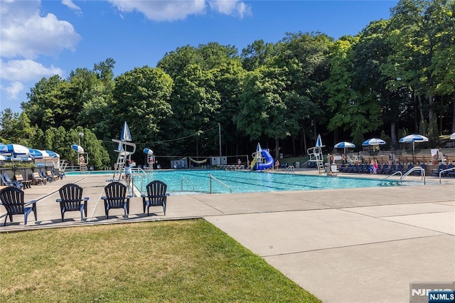 51 Sunrise Ter, Cedar Grove, NJ 07009 - community pool featuring a water slide, a patio, and view of scattered trees
