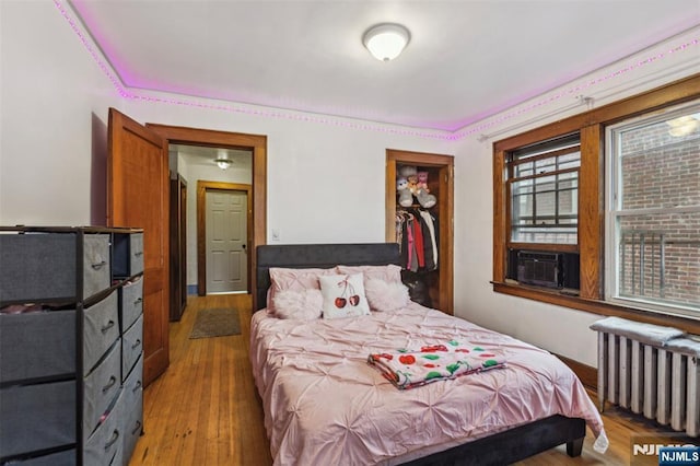 21 Berkeley Ave, Belleville, NJ 07109 - bedroom featuring radiator heating unit, cooling unit, and light wood finished floors