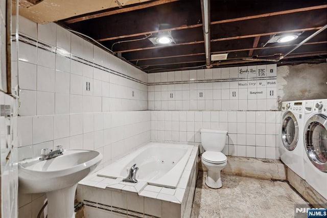 21 Berkeley Ave, Belleville, NJ 07109 - full bath featuring washing machine and clothes dryer, tile walls, a tub with jets, and toilet