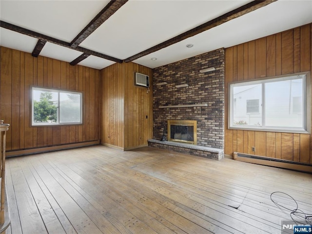 685 Maple Ave, Ridgefield, NJ 07657 - unfurnished living room with a baseboard radiator, wood-type flooring, beam ceiling, wooden walls, and a wall unit AC