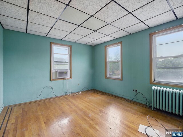 685 Maple Ave, Ridgefield, NJ 07657 - spare room with radiator, hardwood / wood-style flooring, and healthy amount of natural light