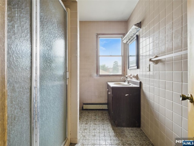 685 Maple Ave, Ridgefield, NJ 07657 - bathroom featuring baseboard heating, tile walls, vanity, and a shower stall