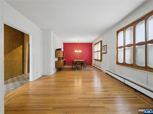 685 Maple Ave, Ridgefield, NJ 07657 - unfurnished dining area with wood finished floors, a chandelier, and baseboard heating