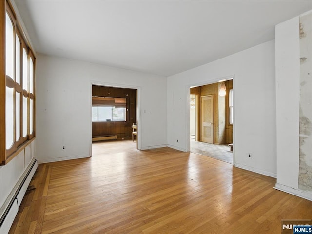 685 Maple Ave, Ridgefield, NJ 07657 - empty room with baseboard heating, light wood-style floors, and baseboards