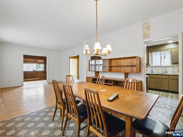 685 Maple Ave, Ridgefield, NJ 07657 - dining room with a chandelier, a baseboard radiator, light wood-style flooring, and baseboards