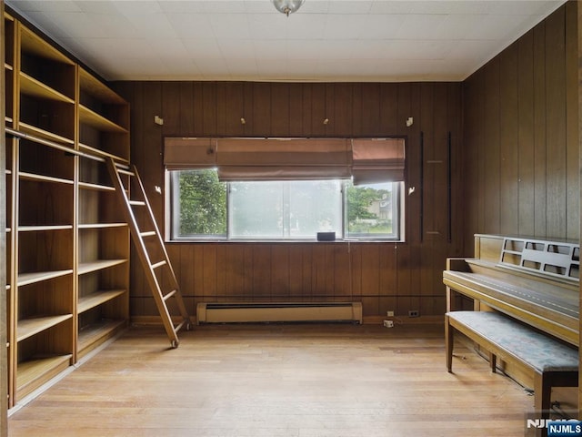 685 Maple Ave, Ridgefield, NJ 07657 - sitting room featuring a baseboard radiator, light wood-style flooring, and wood walls