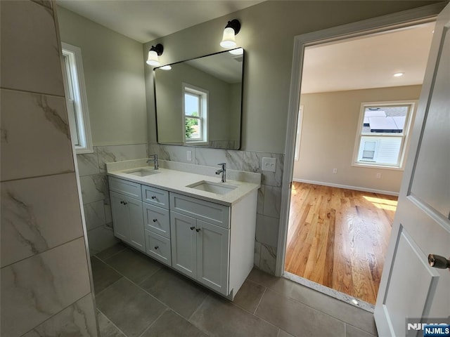510 Anthony Ct, Lyndhurst, NJ 07071 - bathroom featuring tile walls, double vanity, wainscoting, and tile patterned floors