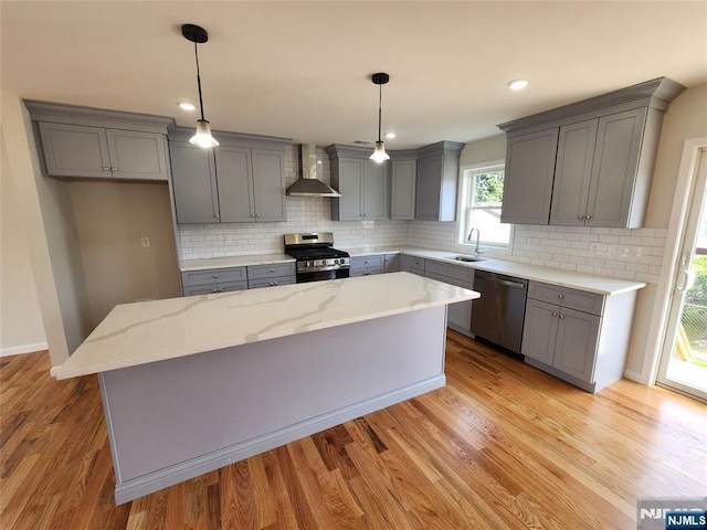 510 Anthony Ct, Lyndhurst, NJ 07071 - kitchen with appliances with stainless steel finishes, wall chimney exhaust hood, gray cabinetry, a sink, and a kitchen island