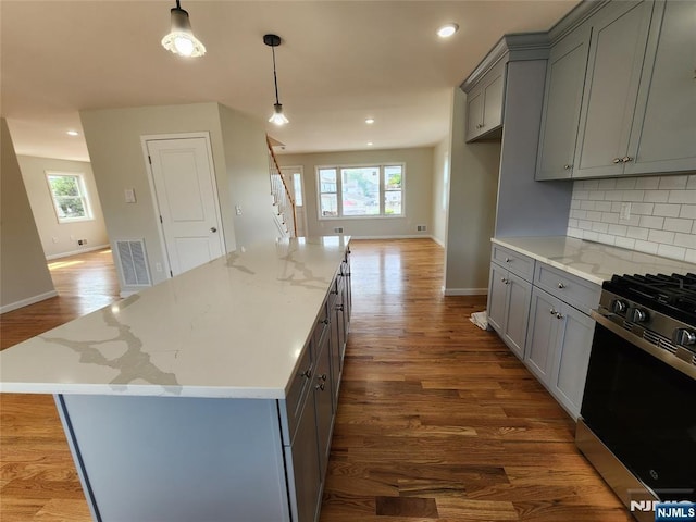 510 Anthony Ct, Lyndhurst, NJ 07071 - kitchen with gray cabinets, stainless steel gas range oven, wood finished floors, decorative backsplash, and baseboards