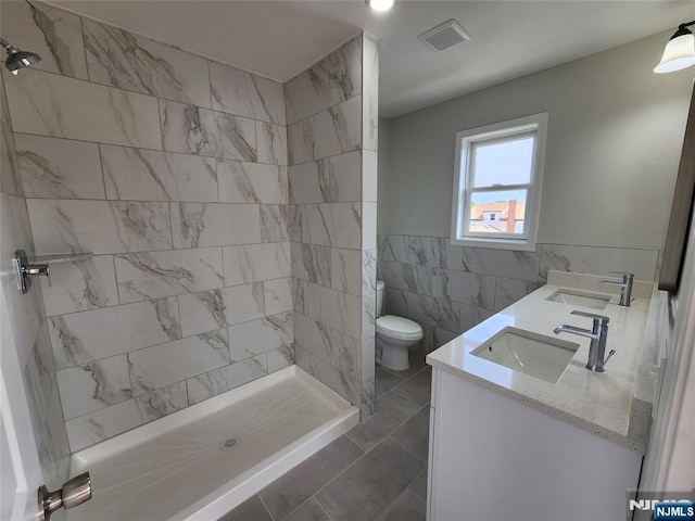 510 Anthony Ct, Lyndhurst, NJ 07071 - full bath with tile walls, double vanity, tiled shower, toilet, and tile patterned flooring