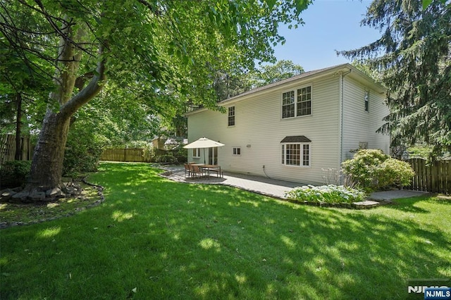 43 Lawrence Pkwy, Tenafly, NJ 07670 - rear view of house with a fenced backyard and a patio area