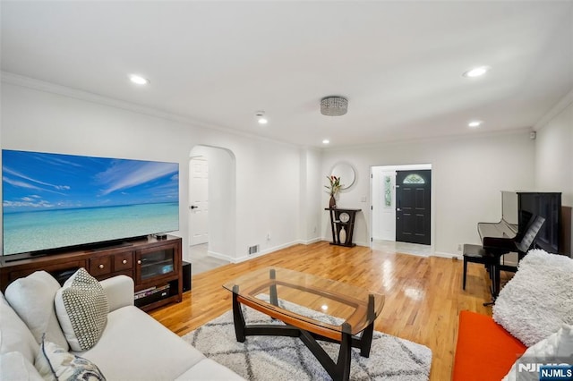 43 Lawrence Pkwy, Tenafly, NJ 07670 - living room featuring crown molding, arched walkways, recessed lighting, and light wood-style floors
