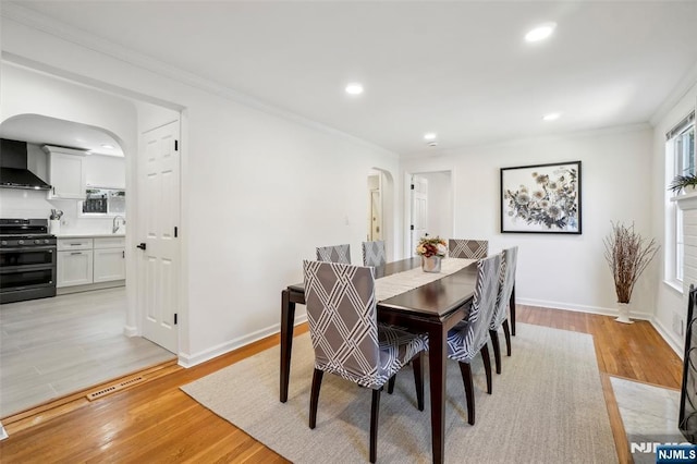 43 Lawrence Pkwy, Tenafly, NJ 07670 - dining room featuring arched walkways, light wood-style floors, crown molding, and recessed lighting