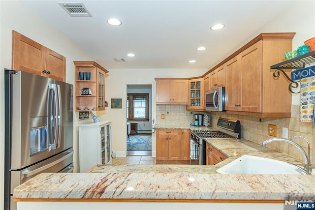 449 E Valley Rd, Montclair, NJ 07043 - kitchen featuring appliances with stainless steel finishes, a sink, light stone counters, tasteful backsplash, and recessed lighting