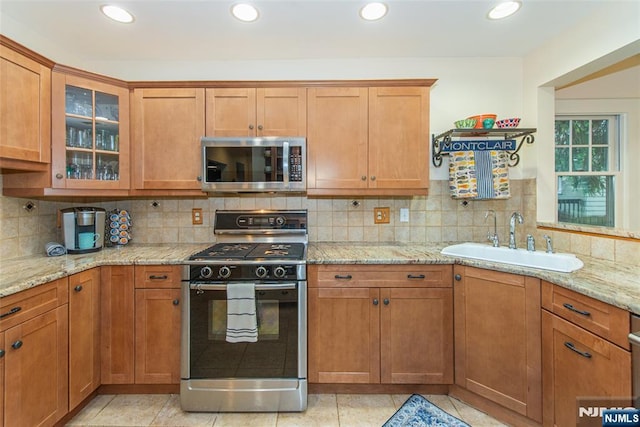 449 E Valley Rd, Montclair, NJ 07043 - kitchen featuring stainless steel microwave, gas stove, a sink, glass insert cabinets, and tasteful backsplash