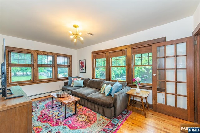 449 E Valley Rd, Montclair, NJ 07043 - living room featuring baseboard heating, a chandelier, and light wood-style floors