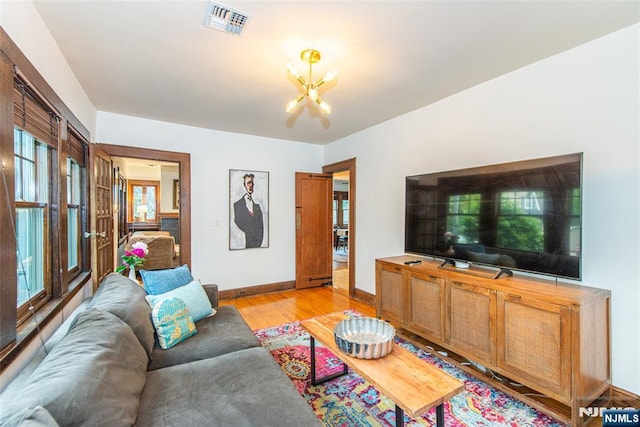449 E Valley Rd, Montclair, NJ 07043 - living room featuring a chandelier, light wood finished floors, and baseboards