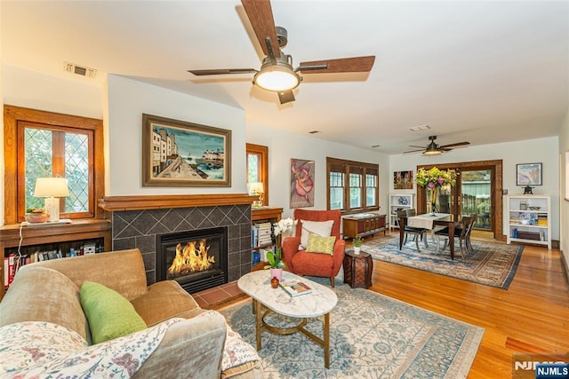 449 E Valley Rd, Montclair, NJ 07043 - living room featuring ceiling fan, wood finished floors, and a tiled fireplace