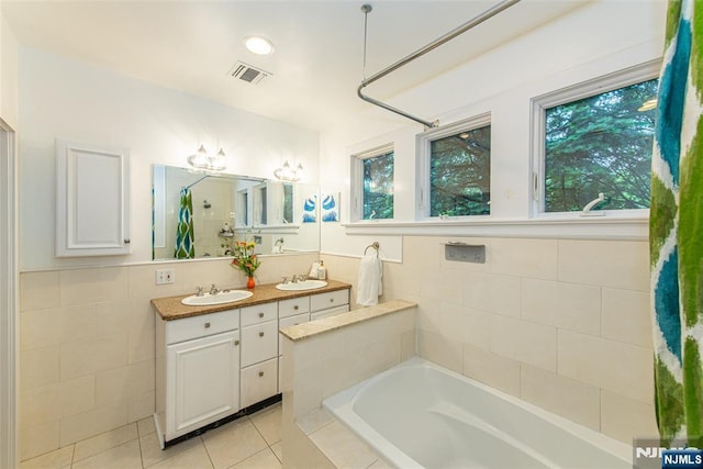 449 E Valley Rd, Montclair, NJ 07043 - bathroom with a bath, double vanity, tile walls, tile patterned flooring, and a shower