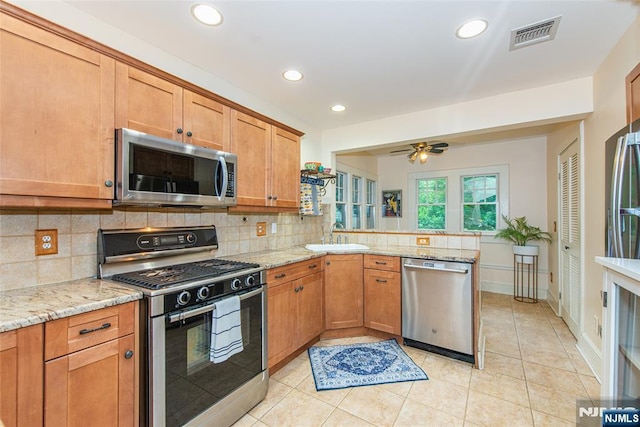 449 E Valley Rd, Montclair, NJ 07043 - kitchen featuring appliances with stainless steel finishes, a peninsula, backsplash, light tile patterned floors, and recessed lighting