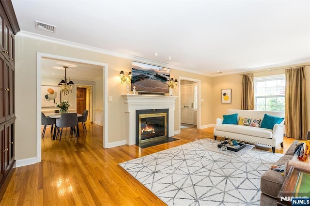 9 Stonewood Pkwy, Verona, NJ 07044 - living area with wood finished floors, crown molding, a fireplace with flush hearth, and baseboards