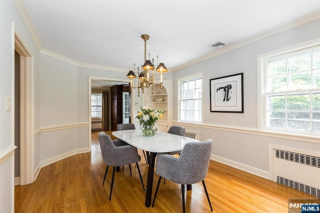 9 Stonewood Pkwy, Verona, NJ 07044 - dining area with radiator, a chandelier, light wood-style flooring, ornamental molding, and baseboards