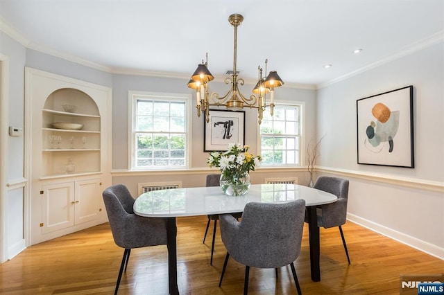 9 Stonewood Pkwy, Verona, NJ 07044 - dining area with a chandelier, ornamental molding, light wood-type flooring, built in shelves, and baseboards