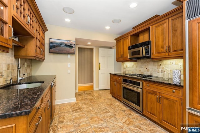9 Stonewood Pkwy, Verona, NJ 07044 - kitchen with stainless steel appliances, a sink, baseboards, brown cabinets, and recessed lighting