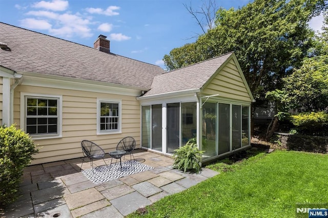 9 Stonewood Pkwy, Verona, NJ 07044 - back of house featuring a shingled roof, a sunroom, a chimney, a patio area, and a lawn