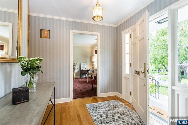 9 Stonewood Pkwy, Verona, NJ 07044 - entrance foyer featuring wallpapered walls, light wood-type flooring, ornamental molding, and baseboards