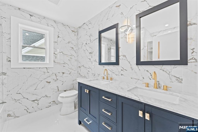 71 Watson Ave, East Orange, NJ 07018 - bathroom with double vanity, toilet, tile walls, and marble finish flooring