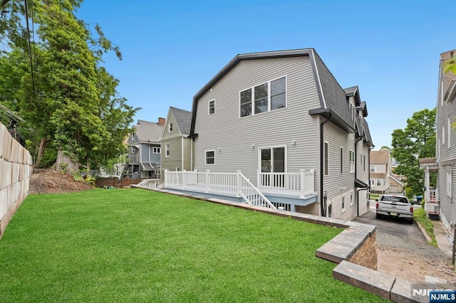 71 Watson Ave, East Orange, NJ 07018 - back of property featuring a wooden deck and a gambrel roof
