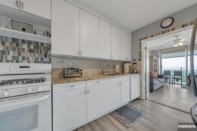 1530 Palisade Ave Unit 21M, Fort Lee, NJ 07024 - kitchen featuring white appliances, light wood finished floors, white cabinetry, decorative backsplash, and a ceiling fan