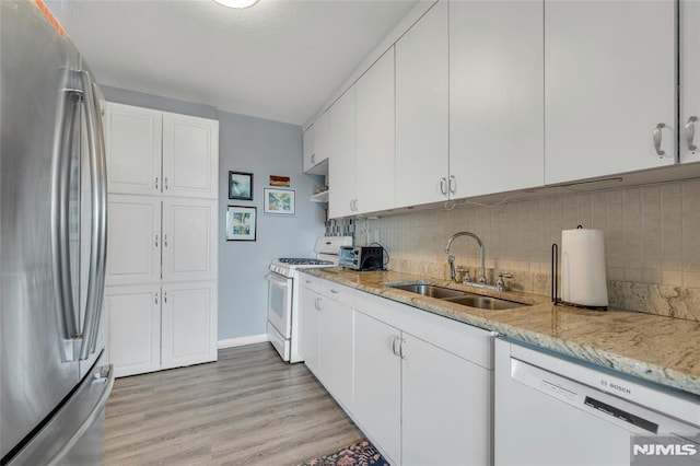 1530 Palisade Ave Unit 21M, Fort Lee, NJ 07024 - kitchen featuring white appliances, light wood-style flooring, white cabinets, tasteful backsplash, and light stone counters