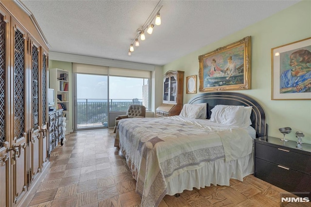 1530 Palisade Ave Unit 21M, Fort Lee, NJ 07024 - bedroom with access to outside and a textured ceiling