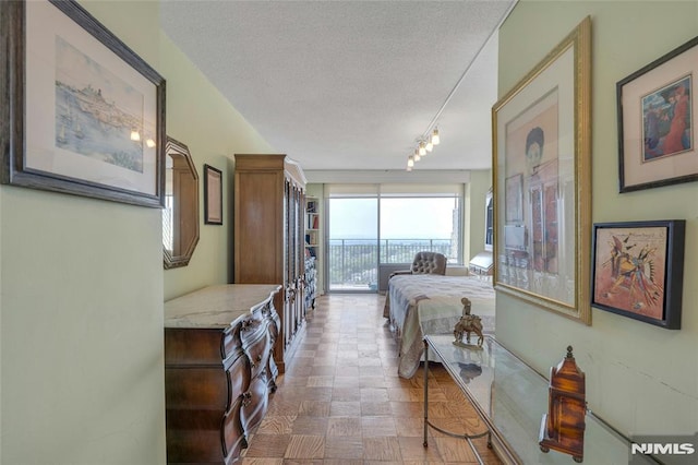 1530 Palisade Ave Unit 21M, Fort Lee, NJ 07024 - bedroom featuring access to outside, a textured ceiling, and track lighting