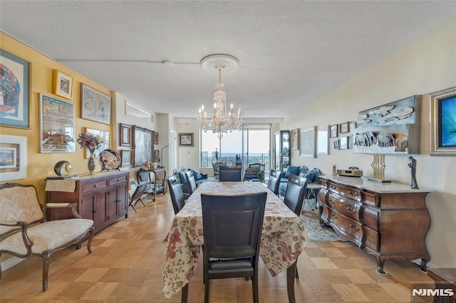 1530 Palisade Ave Unit 21M, Fort Lee, NJ 07024 - dining area with a chandelier and a textured ceiling
