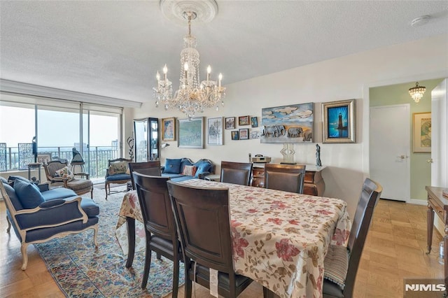 1530 Palisade Ave Unit 21M, Fort Lee, NJ 07024 - dining area with a chandelier and a textured ceiling
