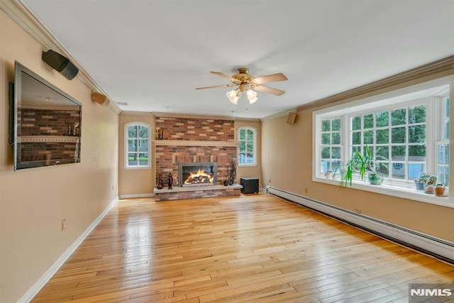 20 W Crescent Ave, Mahwah, NJ 07430 - unfurnished living room with a ceiling fan, a baseboard heating unit, light wood finished floors, crown molding, and a fireplace