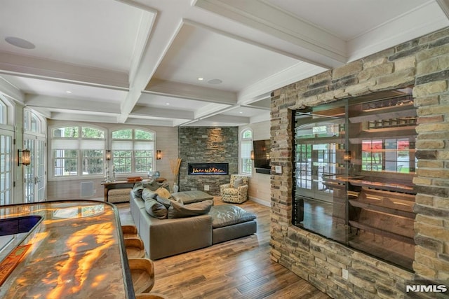 20 W Crescent Ave, Mahwah, NJ 07430 - living area with wood finished floors, beamed ceiling, coffered ceiling, and a stone fireplace