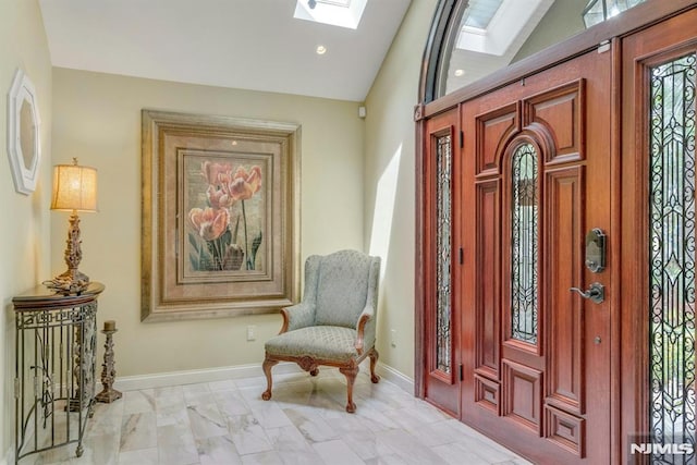 20 W Crescent Ave, Mahwah, NJ 07430 - entrance foyer featuring a skylight, vaulted ceiling, light marble finish flooring, and baseboards