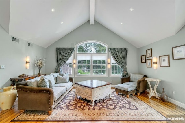 20 W Crescent Ave, Mahwah, NJ 07430 - living room featuring light wood finished floors, beamed ceiling, high vaulted ceiling, and baseboards