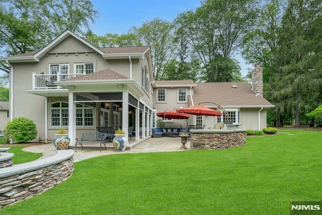 20 W Crescent Ave, Mahwah, NJ 07430 - rear view of house featuring a balcony, a patio, a lawn, and stucco siding
