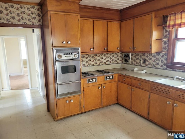 55 James, Bloomfield, NJ 07003 - kitchen featuring appliances with stainless steel finishes, a warming drawer, light flooring, and brown cabinetry
