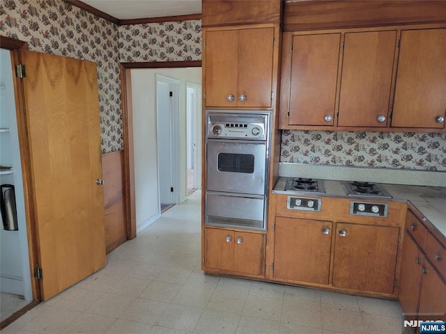 55 James, Bloomfield, NJ 07003 - kitchen with stainless steel oven, wallpapered walls, a warming drawer, brown cabinets, and light floors