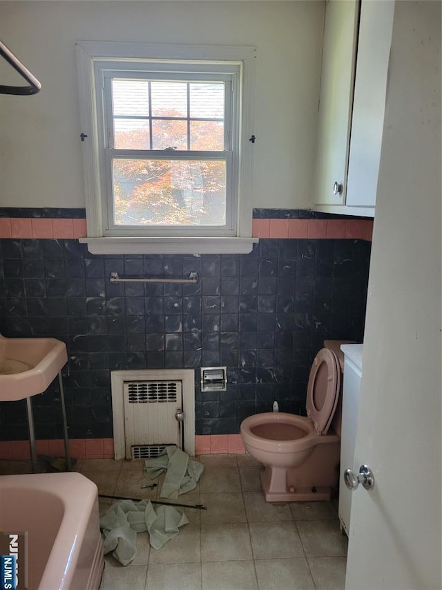 55 James, Bloomfield, NJ 07003 - bathroom featuring radiator heating unit, tile walls, tile patterned flooring, toilet, and wainscoting
