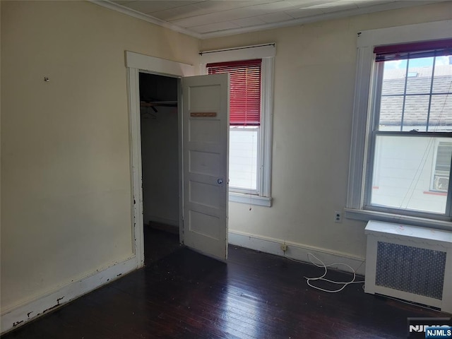 55 James, Bloomfield, NJ 07003 - unfurnished bedroom featuring radiator heating unit, wood-type flooring, multiple windows, ornamental molding, and baseboards